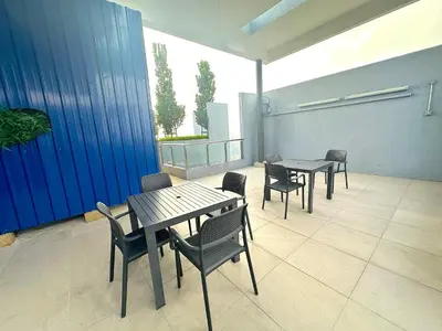 a group of tables and chairs on a patio at Neu Suites By Serenity Homes Near Gleneagles, KLCC & LRT in Kuala Lumpur