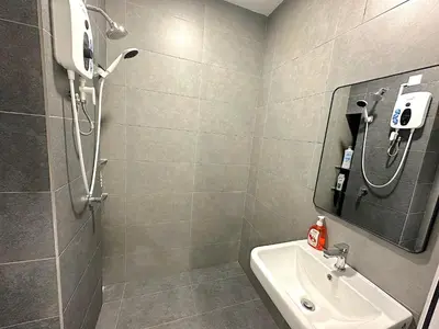 a bathroom with a shower and a sink and a mirror at Neu Suites By Serenity Homes Near Gleneagles, KLCC & LRT in Kuala Lumpur