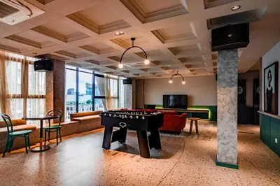a living room with a pool table and ping pong ball at Scarletz Suites Klcc by Signature Apartment in Kuala Lumpur
