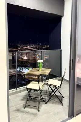 a table and chairs with a view of a city at The Home by Fidi @ Continew Residence (Near TREC) in Kuala Lumpur