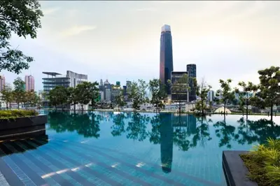 a swimming pool with a city skyline in the background at The Home by Fidi @ Continew Residence (Near TREC) in Kuala Lumpur