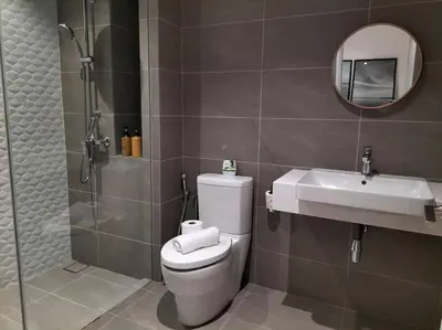a bathroom with a toilet and a sink and a shower at Quill Residence by Cozy Simple Stay in Kuala Lumpur