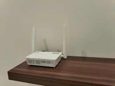 a white appliance sitting on top of a wooden shelf at Quill Residence by Cozy Simple Stay in Kuala Lumpur