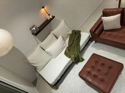 a living room with a couch and a chair at Quill Residence by Cozy Simple Stay in Kuala Lumpur