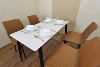 a white table with chairs and plates on it at The Sandstone - Bangsar Trade Centre in Kuala Lumpur