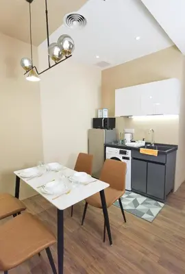 a kitchen with a table and chairs in a kitchen at The Sandstone - Bangsar Trade Centre in Kuala Lumpur
