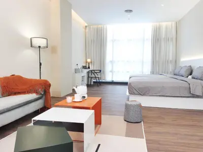 a bedroom with a bed and a couch and a table at The Sandstone - Bangsar Trade Centre in Kuala Lumpur