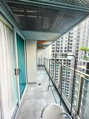 a balcony of a building with chairs and windows at Summer Suites KLCC By GRAND CENTRAL in Kuala Lumpur