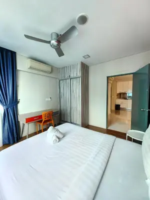 a bedroom with a large white bed with a ceiling fan at Summer Suites KLCC By GRAND CENTRAL in Kuala Lumpur