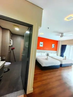 a hotel room with two beds and a bathroom at Summer Suites KLCC By GRAND CENTRAL in Kuala Lumpur