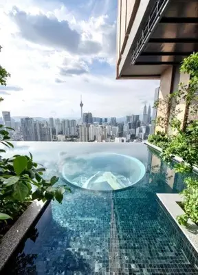 a swimming pool with a view of a city at Lucentia Global Signature Suites Kuala Lumpur in Kuala Lumpur