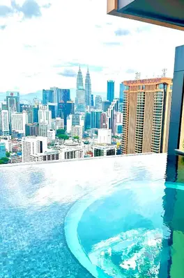 a swimming pool with a view of a city at Lucentia Global Signature Suites Kuala Lumpur in Kuala Lumpur