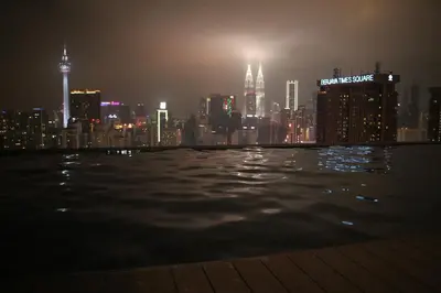 a view of a city skyline at night at Lucentia Global Signature Suites Kuala Lumpur in Kuala Lumpur