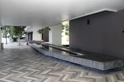 a lobby with a long bench in a building at Lucentia Global Signature Suites Kuala Lumpur in Kuala Lumpur