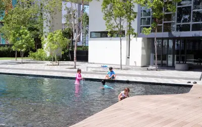 a group of children playing in the water in a fountain at Lucentia Global Signature Suites Kuala Lumpur in Kuala Lumpur