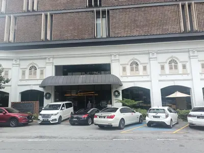 a group of cars parked in a parking lot in front of a building at James' Studio unit Maison 101 at Heritage Row, Kuala Lumpur in Kuala Lumpur