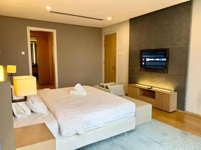 a bedroom with a large white bed and a flat screen tv at 188 suites 2bedroom/4pax/13minute walk to klcc in Kuala Lumpur