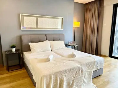a bedroom with a large bed with white sheets at 188 suites 2bedroom/4pax/13minute walk to klcc in Kuala Lumpur
