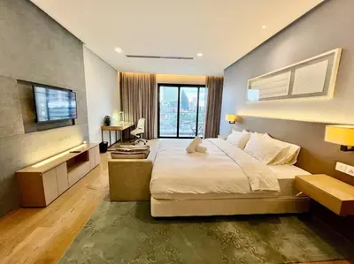 a bedroom with a large bed and a television at 188 suites 2bedroom/4pax/13minute walk to klcc in Kuala Lumpur