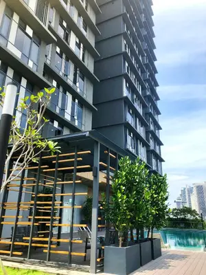 a large apartment building with a pool in front of it at M and S Suite at Societe Suites Sri Hartamas, Mont Kiara in Kuala Lumpur