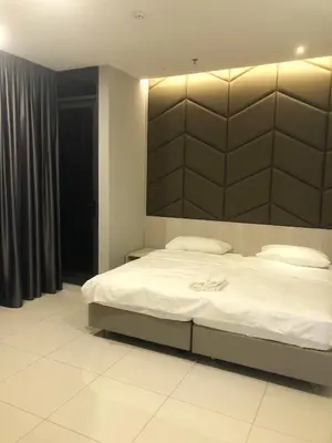 a bedroom with a large bed with a large headboard at M and S Suite at Societe Suites Sri Hartamas, Mont Kiara in Kuala Lumpur
