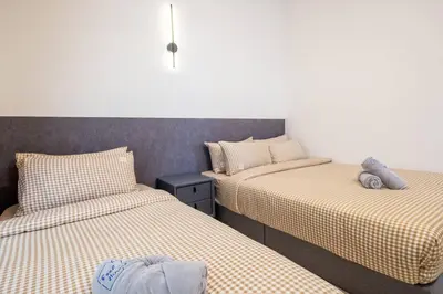 a room with two twin beds in a room at RetroJazz Kids House 15pax 4Room in Kuala Lumpur