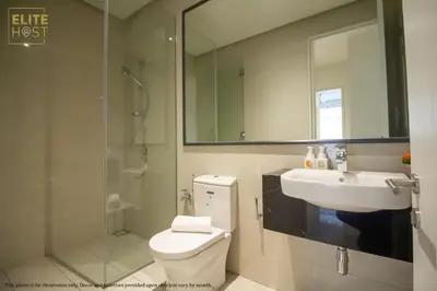 a bathroom with a sink and a toilet and a mirror at PAVILION EMBASSY KLCC By ELITE HOST in Kuala Lumpur