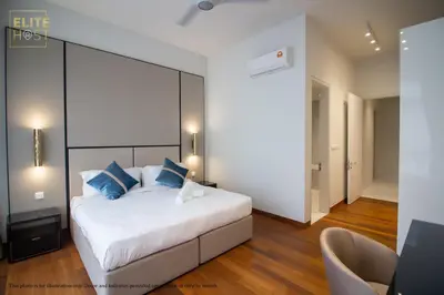 a bedroom with a large white bed with blue pillows at PAVILION EMBASSY KLCC By ELITE HOST in Kuala Lumpur