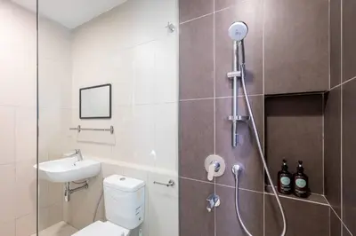 a bathroom with a shower with a toilet and a sink at Kids Wonderland opposite MyTown near TRX Mall MRT in Kuala Lumpur