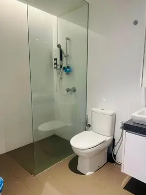 a bathroom with a toilet and a glass shower at KL Sentral Bangsar Suites EST by Inam Suites in Kuala Lumpur