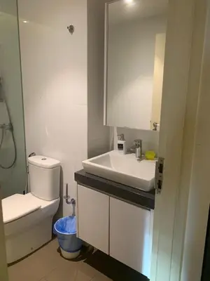 a white bathroom with a sink and a toilet at KL Sentral Bangsar Suites EST by Inam Suites in Kuala Lumpur