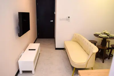 a waiting room with a chair and a table at Neu Suites by Snugster 2 Bedroom, 3km to KLCC in Kuala Lumpur