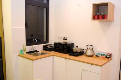 a kitchen with a sink and a microwave at Neu Suites by Snugster 2 Bedroom, 3km to KLCC in Kuala Lumpur