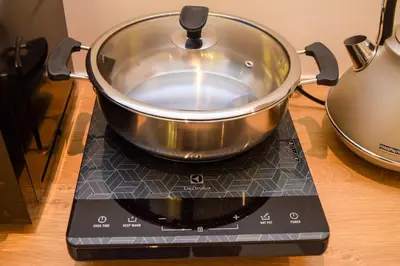 a pot sitting on top of a stove at Neu Suites by Snugster 2 Bedroom, 3km to KLCC in Kuala Lumpur