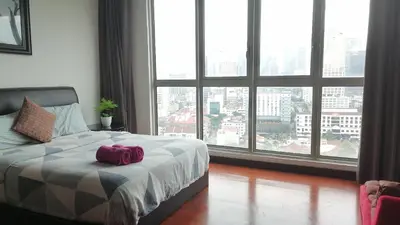 a bedroom with a bed with a large window at Spritz Empire Regalia Suites & Residence in Kuala Lumpur