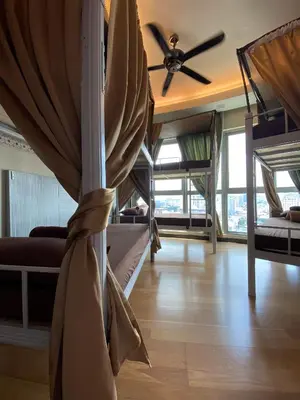 a room with bunk beds and a ceiling fan at Regalia BestFriend Hostel in Kuala Lumpur