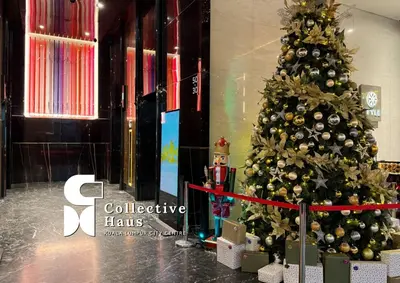 a christmas tree in a building with presents around it at The Platinum 2 Kuala Lumpur By Collective Haus in Kuala Lumpur