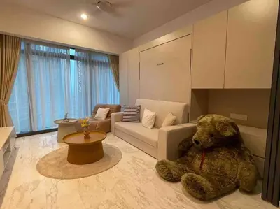 a teddy bear sitting on the floor in a living room at NEW! Eaton Infinity SKY POOL KLCC view Pavilion in Kuala Lumpur