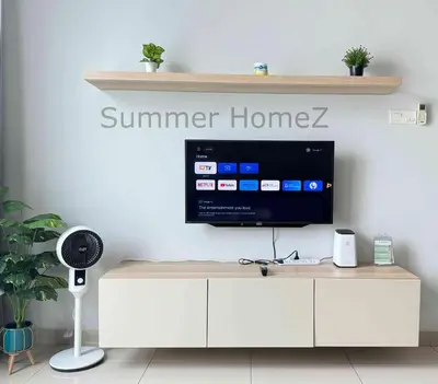 a living room with a tv on a white cabinet at 3BR 5-6Pax Zetapark Setapak Central Near Zoo in Kuala Lumpur