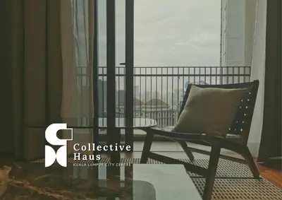 a chair and a table in a room with a window at The Mews KLCC Kuala Lumpur by Collective Haus in Kuala Lumpur