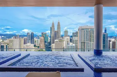 a view of a city skyline from a hot tub at CL24A 5-6pax KLCC Sky Pool Condo in Kuala Lumpur