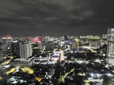a city lit up at night with buildings at CL24A 5-6pax KLCC Sky Pool Condo in Kuala Lumpur