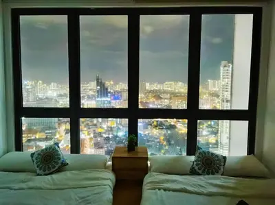 a room with two beds and a large window at CL24A 5-6pax KLCC Sky Pool Condo in Kuala Lumpur