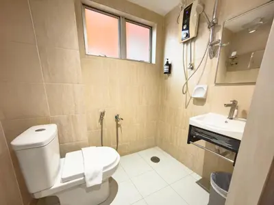 a bathroom with a toilet and a sink at Living At DSulaiman Hotel in Kuala Lumpur