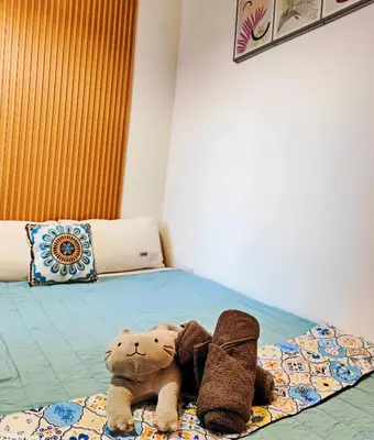 a stuffed animal is laying on a bed at CL24B 2-3pax KLCC Apartment in Kuala Lumpur