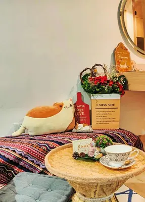 a table with a cat sitting on top of a bed at CL24B 2-3pax KLCC Apartment in Kuala Lumpur