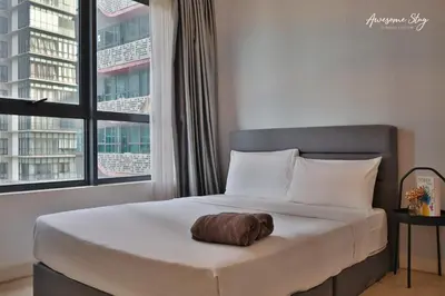 a bed with a pillow on it in a room with windows at Arte plus by 3BR sweet home in Kuala Lumpur