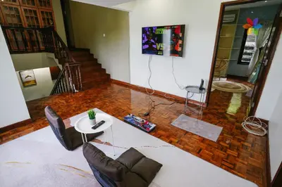 a living room with a white table and chairs at 40P, Bangsar Villa with Pool/Karaoke/Gathering/BBQ in Kuala Lumpur