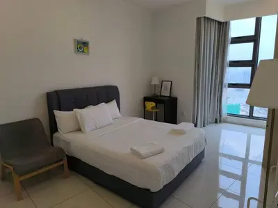 a bedroom with a bed and a chair and a window at 043 Sweet Home Robertson in Kuala Lumpur