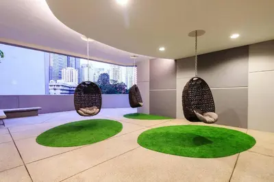 a room with three circular chairs and green grass at 043 Sweet Home Robertson in Kuala Lumpur
